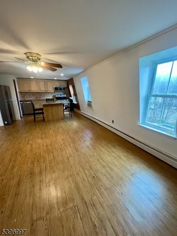 a room with wooden floor and furniture