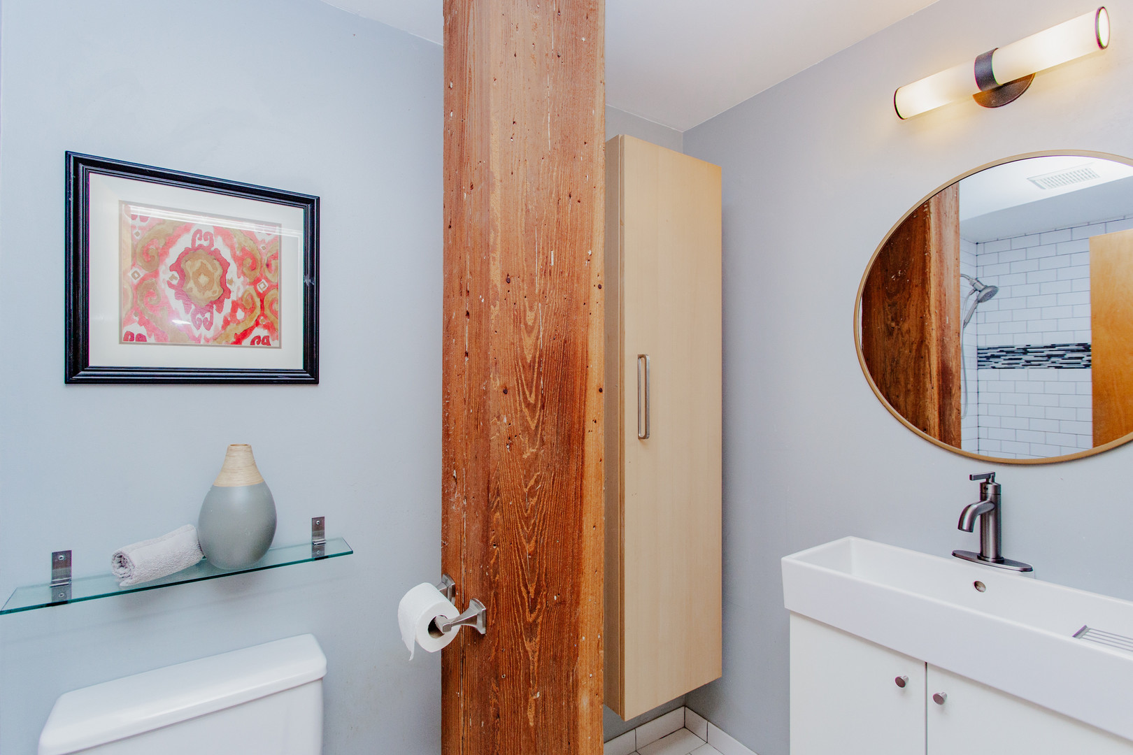 4745 North Ravenswood Avenue, Unit 210 Chicago, IL 60640 - Photo 12 of 23 a bathroom with a sink and a mirror