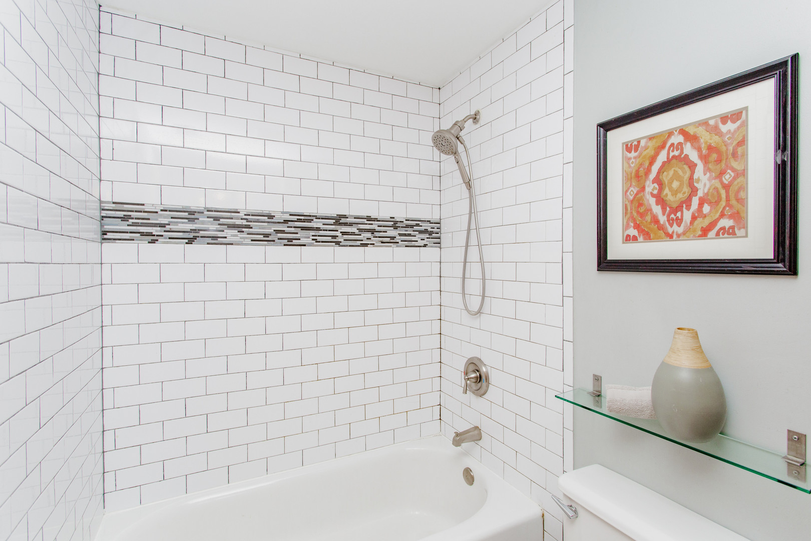 4745 North Ravenswood Avenue, Unit 210 Chicago, IL 60640 - Photo 13 of 23 a bathroom with a bathtub and shower