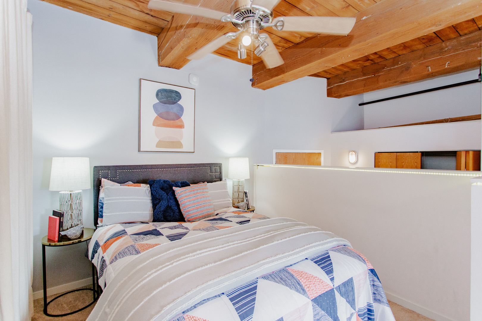 4745 North Ravenswood Avenue, Unit 210 Chicago, IL 60640 - Photo 7 of 23 a bedroom with a bed and a painting on the wall