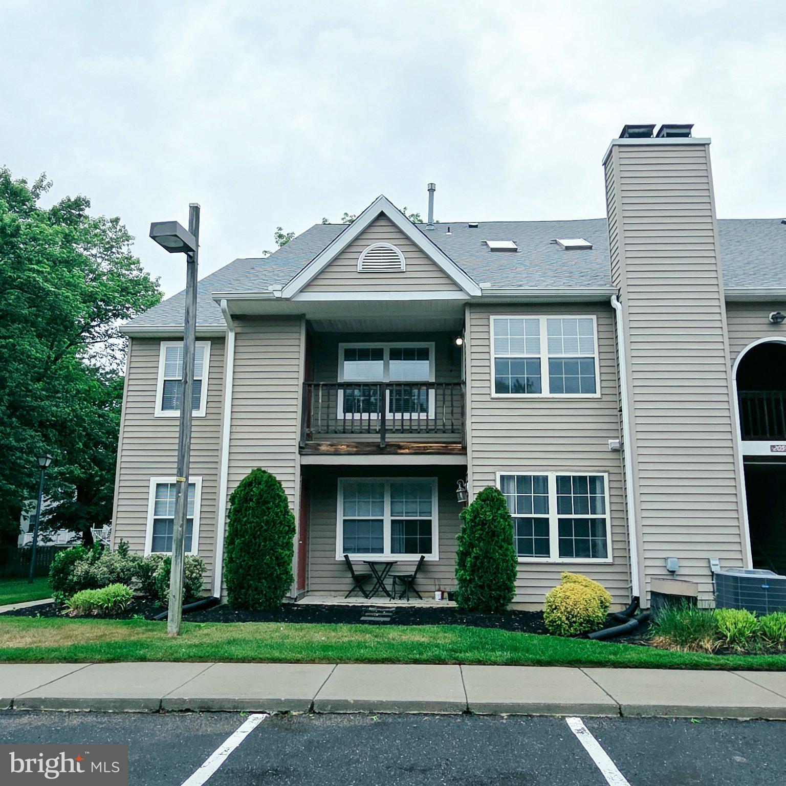 208 Ashley Run Voorhees, NJ 08043 - Photo 23 of 23 a front view of a house with garden and plants