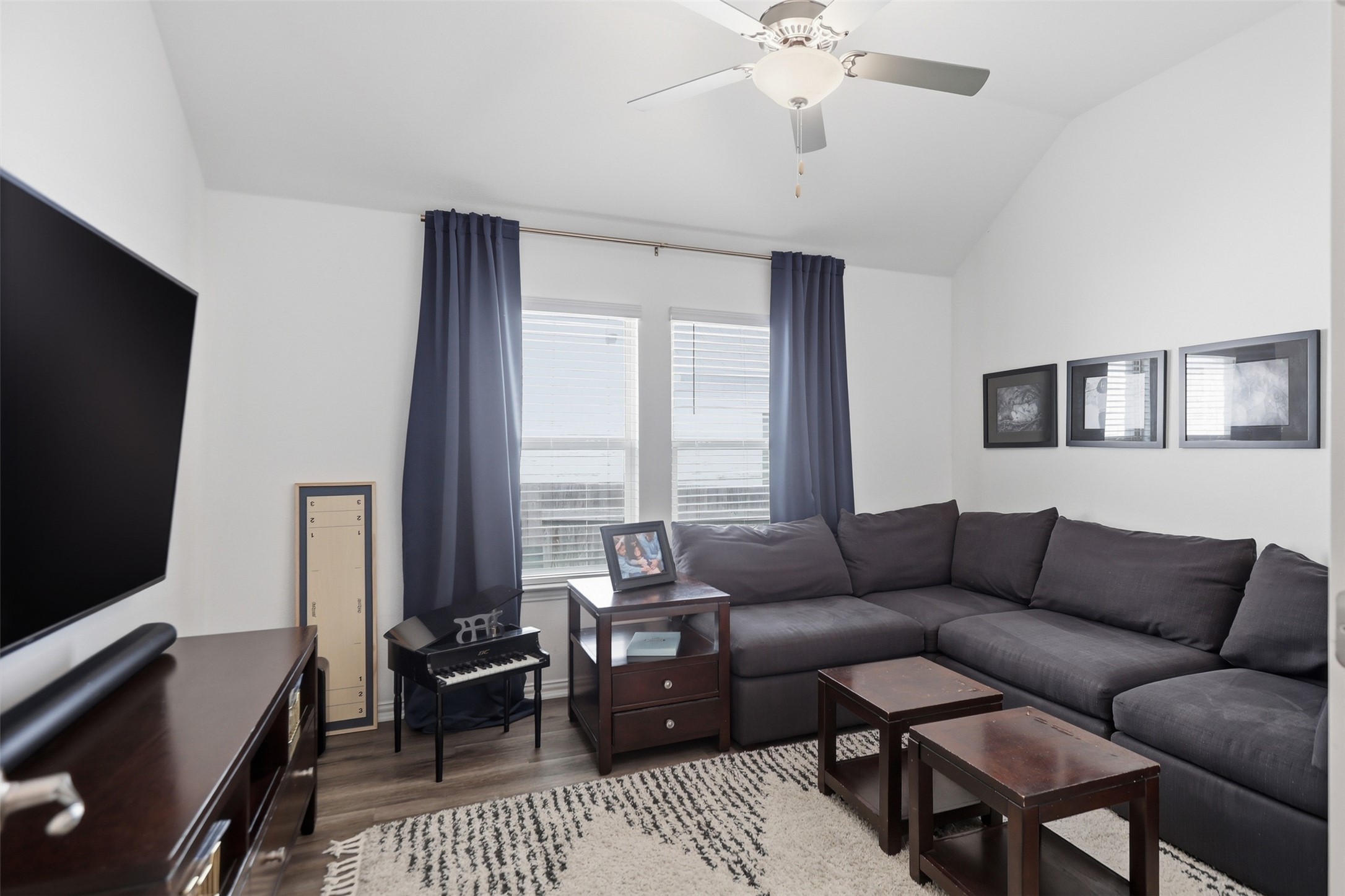 544 Cherrystone Loop Buda, TX 78610 - Photo 25 of 40 a living room with furniture and a flat screen tv