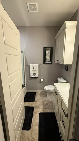 a bathroom with a sink a toilet and a mirror