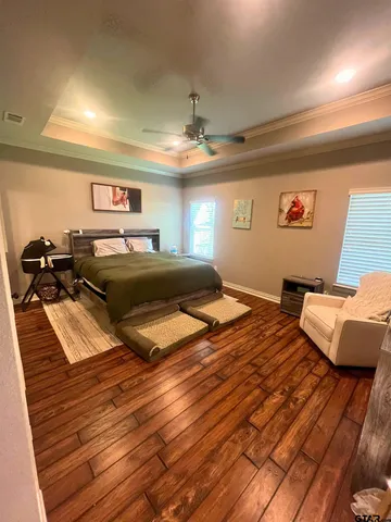 a bedroom with a bed and a chandelier