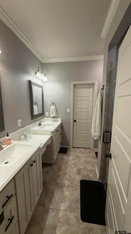 a spacious bathroom with a double vanity sink and mirror