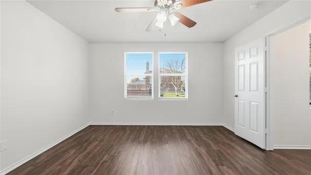 wooden floor in an empty room with a window