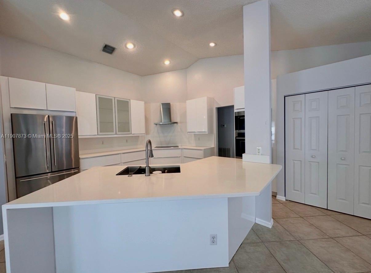 a kitchen with stainless steel appliances a refrigerator and a sink