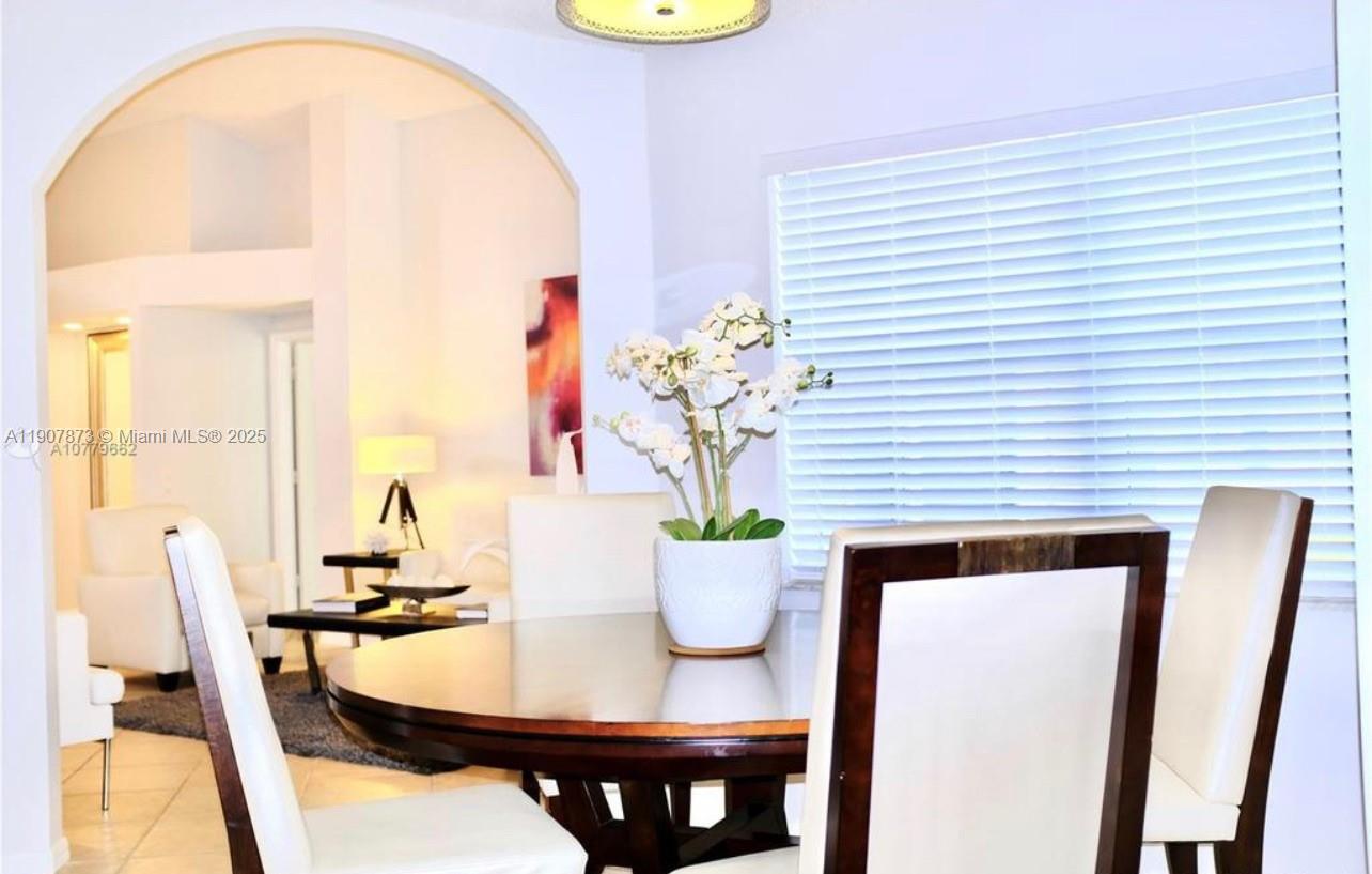 3341 Overlook Road Davie, FL 33328 - Photo 16 of 30 a view of a dining room with furniture and a potted plant