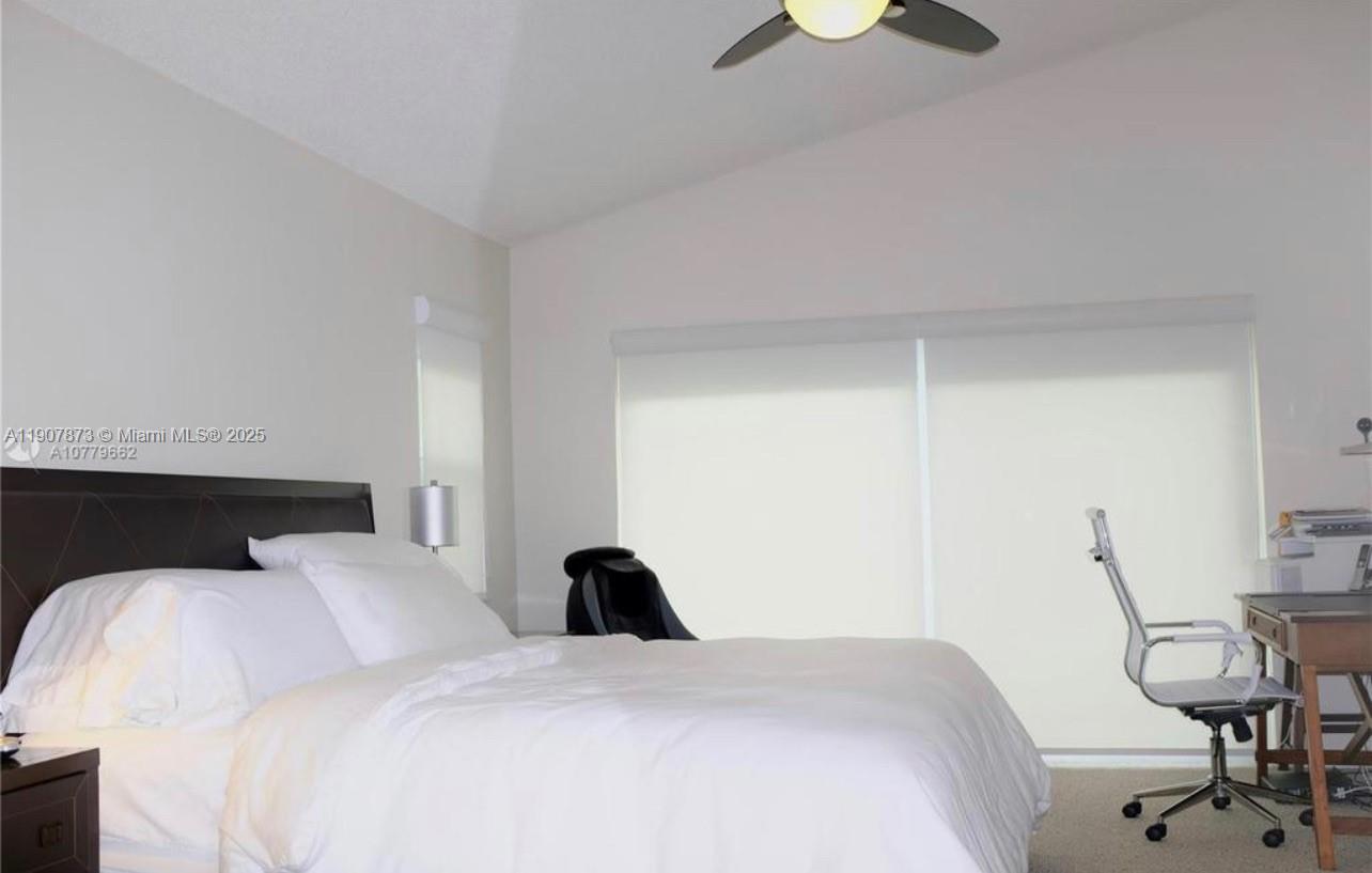 3341 Overlook Road Davie, FL 33328 - Photo 19 of 30 a bedroom with a bed and a chandelier