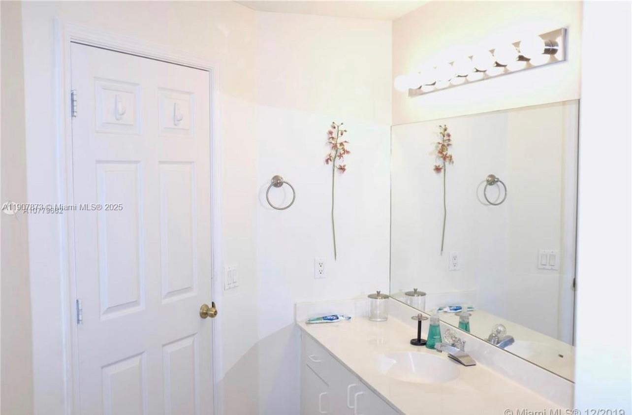 3341 Overlook Road Davie, FL 33328 - Photo 27 of 30 a bathroom with a sink and a mirror