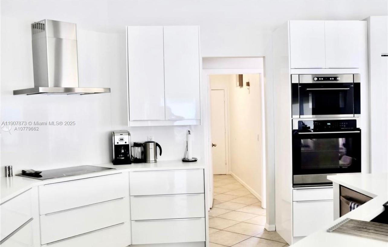 3341 Overlook Road Davie, FL 33328 - Photo 4 of 30 a kitchen with stainless steel appliances a refrigerator and cabinets
