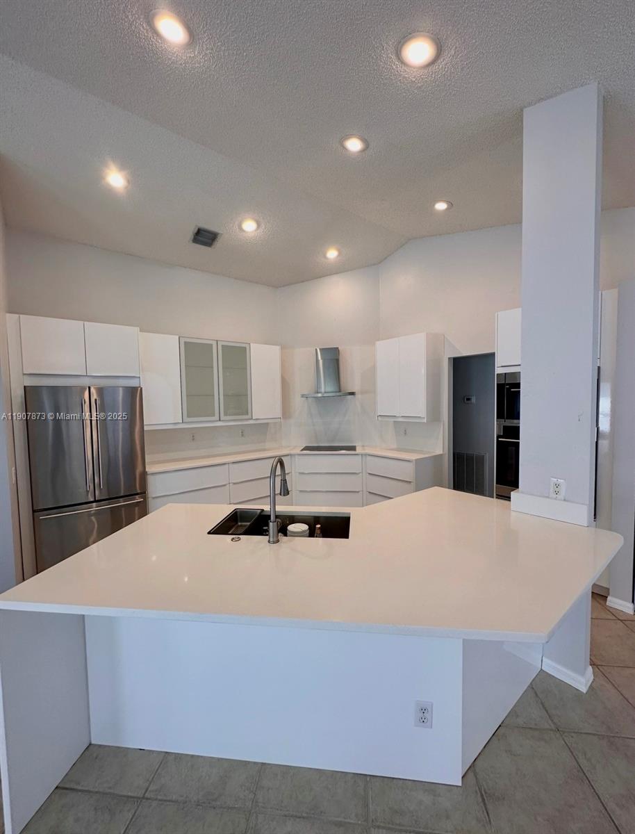 3341 Overlook Road Davie, FL 33328 - Photo 7 of 30 a kitchen with stainless steel appliances a sink and a refrigerator