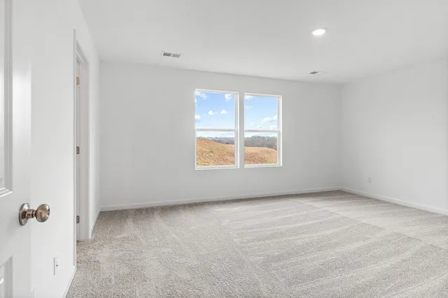 a view of an empty room and a window