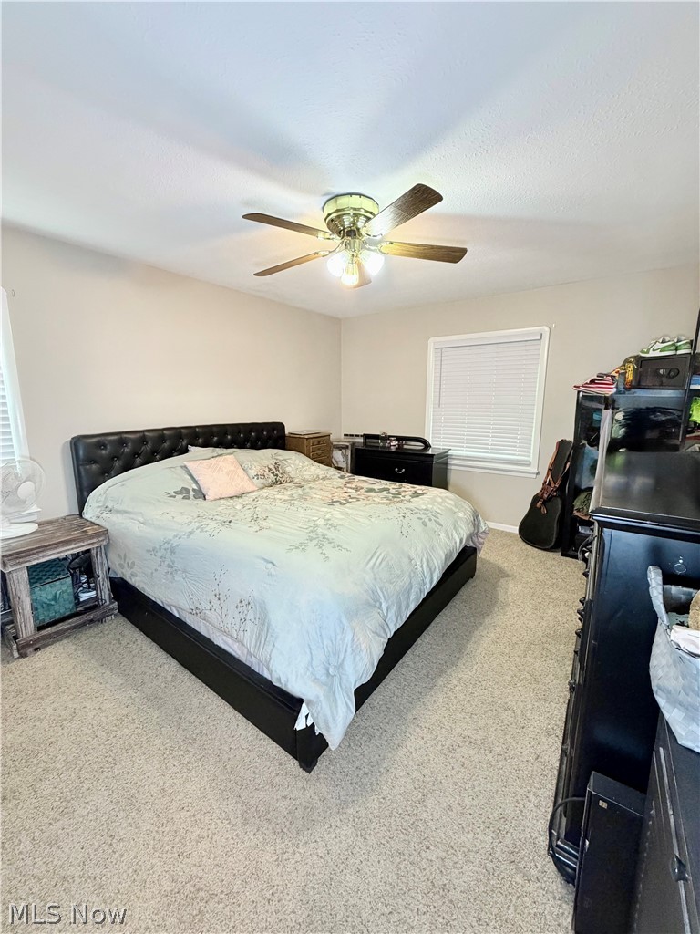 32125 Densmore Road Willowick, OH 44095 - Photo 14 of 23 Carpeted room featuring a ceiling fan with integrated lighting, a window with blinds, and neutral-toned walls