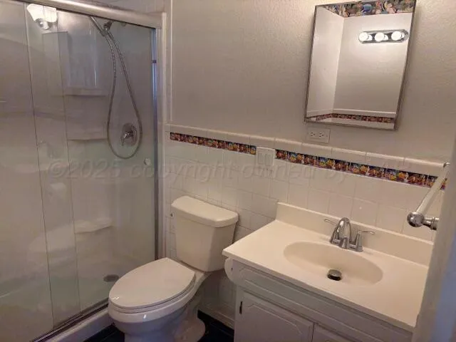 a white toilet sitting next to a bathroom sink