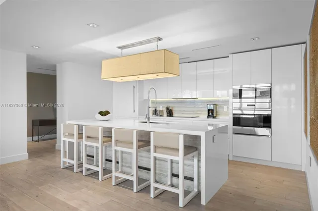 a kitchen with cabinets and chairs