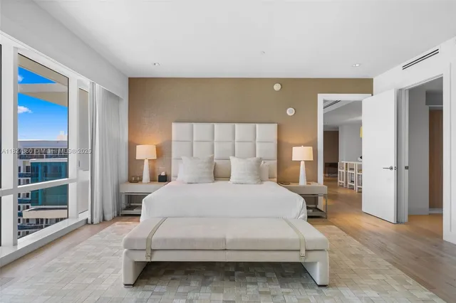 a spacious bedroom with a bed and a cabinet