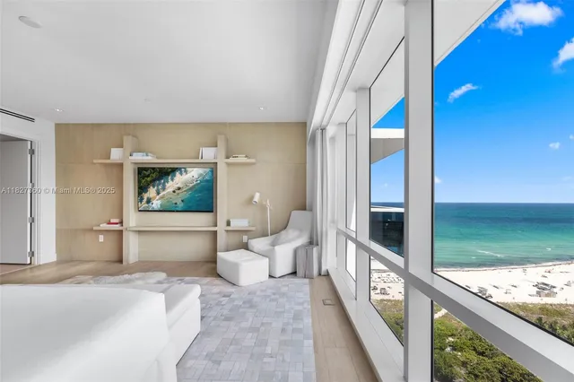 a bedroom with a bed and glass door