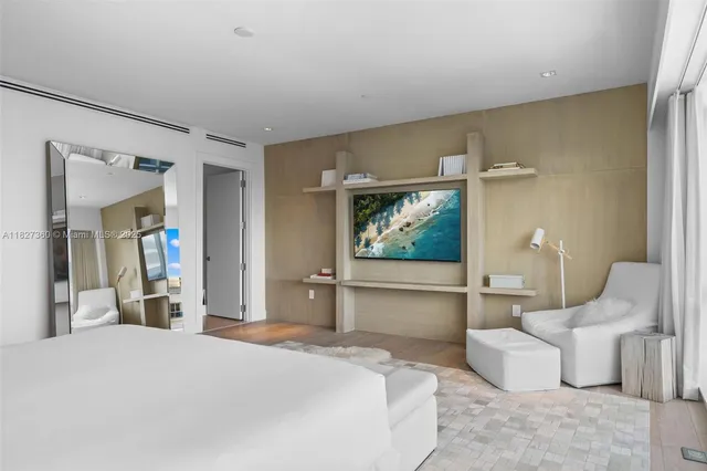 a bedroom with a bed and a large window