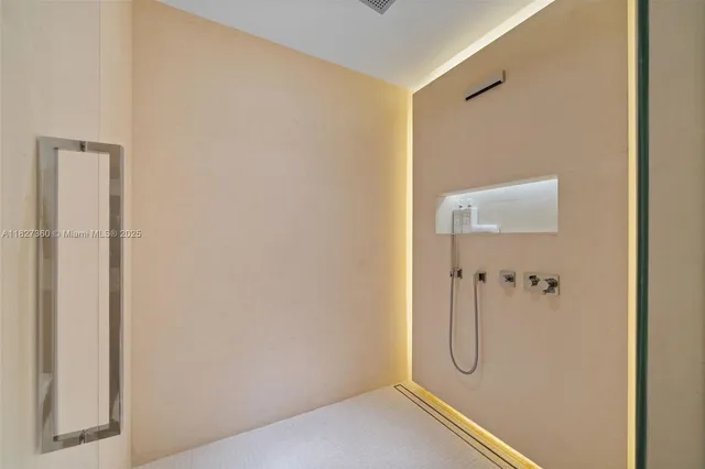 a bathroom with a glass shower door