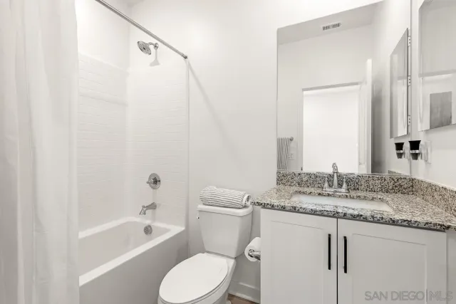 a living room with furniture and flowers