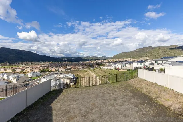 a bathroom with a granite countertop sink a mirror and a shower