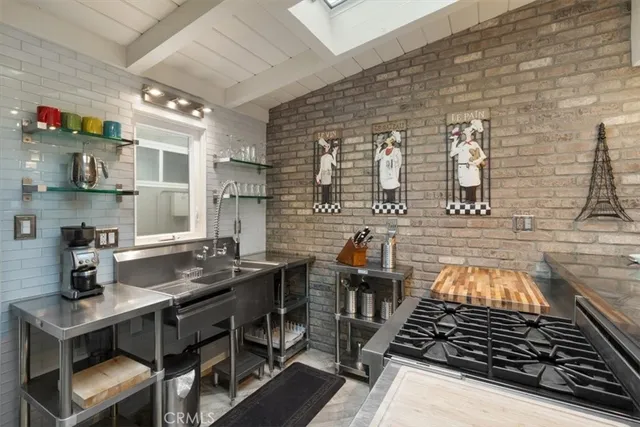 a kitchen with stainless steel appliances granite countertop a stove and a sink