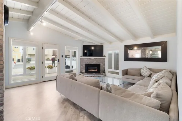 a living room with furniture and kitchen view
