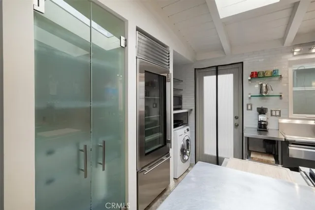 a kitchen with a sink and chairs