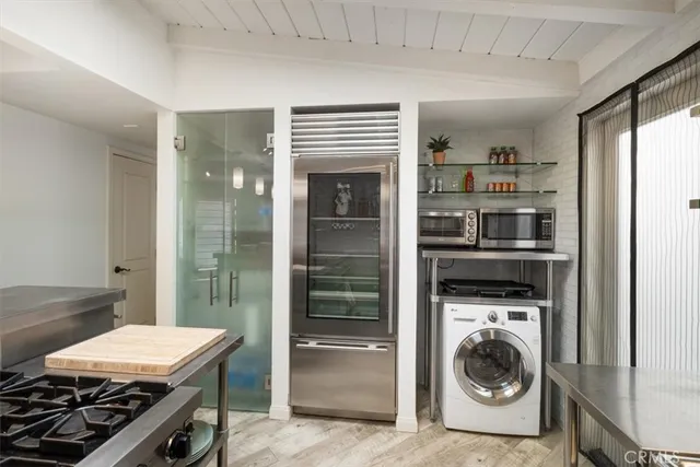 a kitchen with stainless steel appliances granite countertop a sink and wooden cabinets