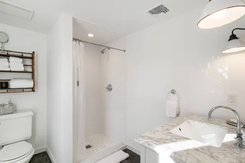 a bathroom with a sink toilet and shower