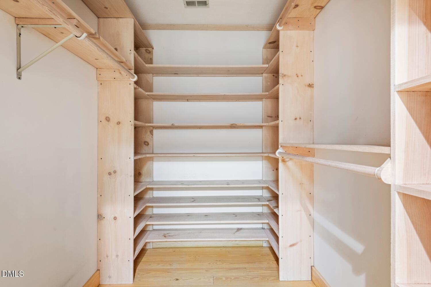 7391 Howerton Road Elon, NC 27244 - Photo 37 of 53 Custom wood shelving, integrated hanging rods, and wood-finish flooring