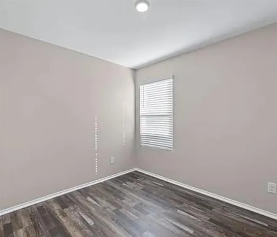 a view of kitchen with refrigerator and windows