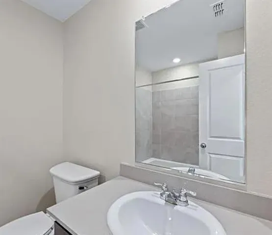 a kitchen with a refrigerator and a sink