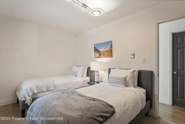 a bedroom with bed and painting on the wall