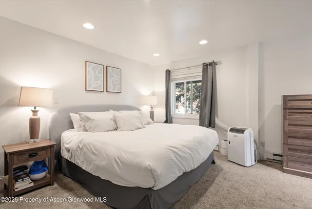 a bedroom with a bed and a lamp