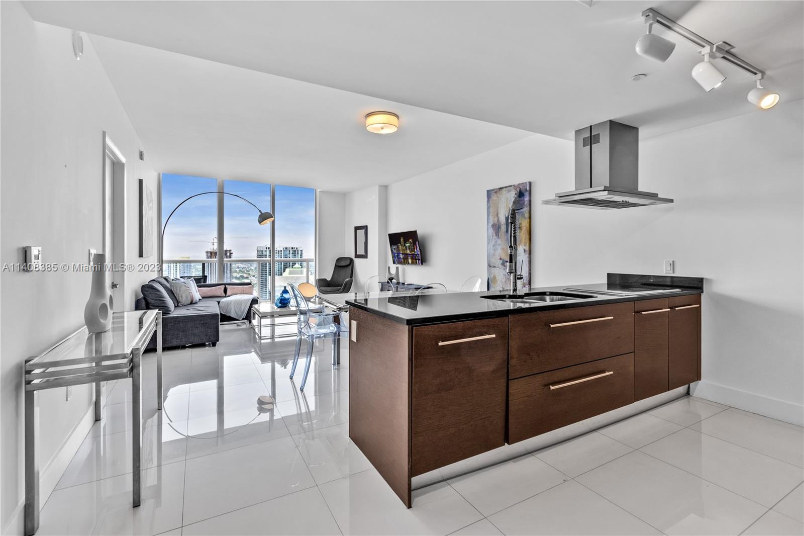 a kitchen with cabinets and chairs