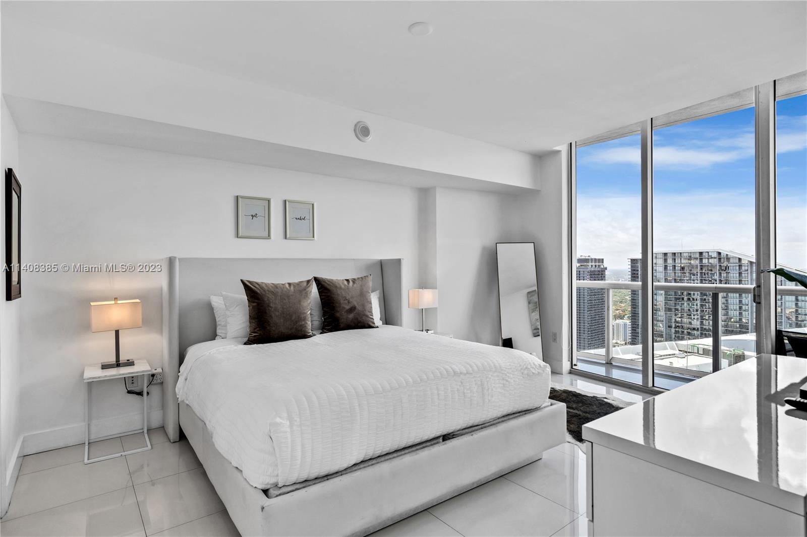 Brickell Miami, FL 33131 - Photo 12 of 25 a large bedroom with a bed and glass door