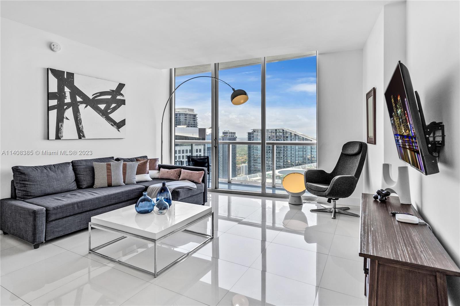 Brickell Miami, FL 33131 - Photo 3 of 25 a living room with furniture floor to ceiling window and flat screen tv