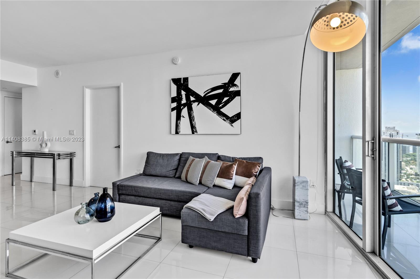 Brickell Miami, FL 33131 - Photo 4 of 25 a living room with furniture and a lamp