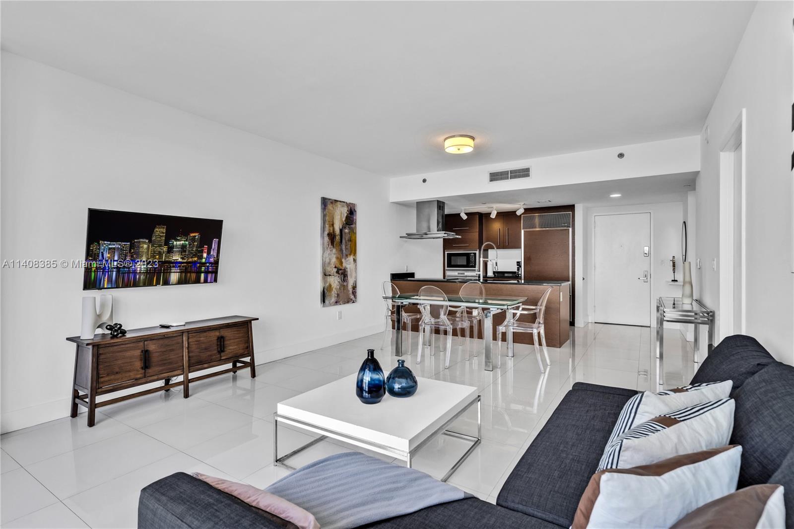 Brickell Miami, FL 33131 - Photo 5 of 25 a living room with furniture and a flat screen tv