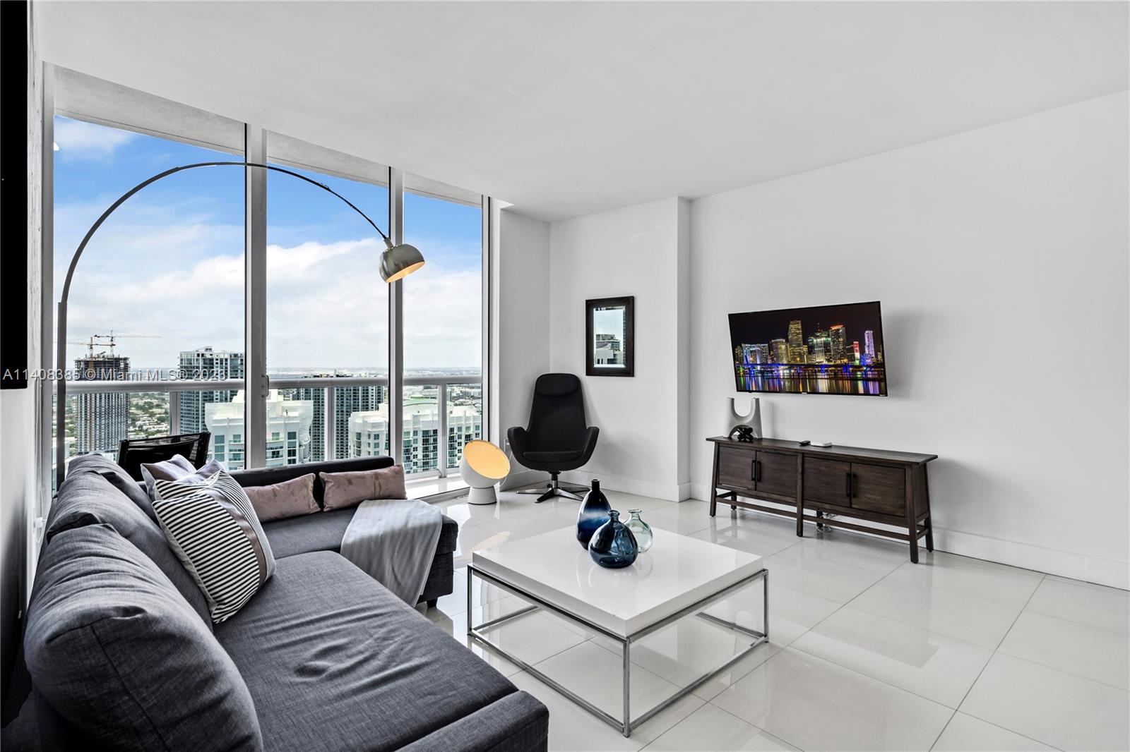 Brickell Miami, FL 33131 - Photo 6 of 25 a living room with furniture and a large window