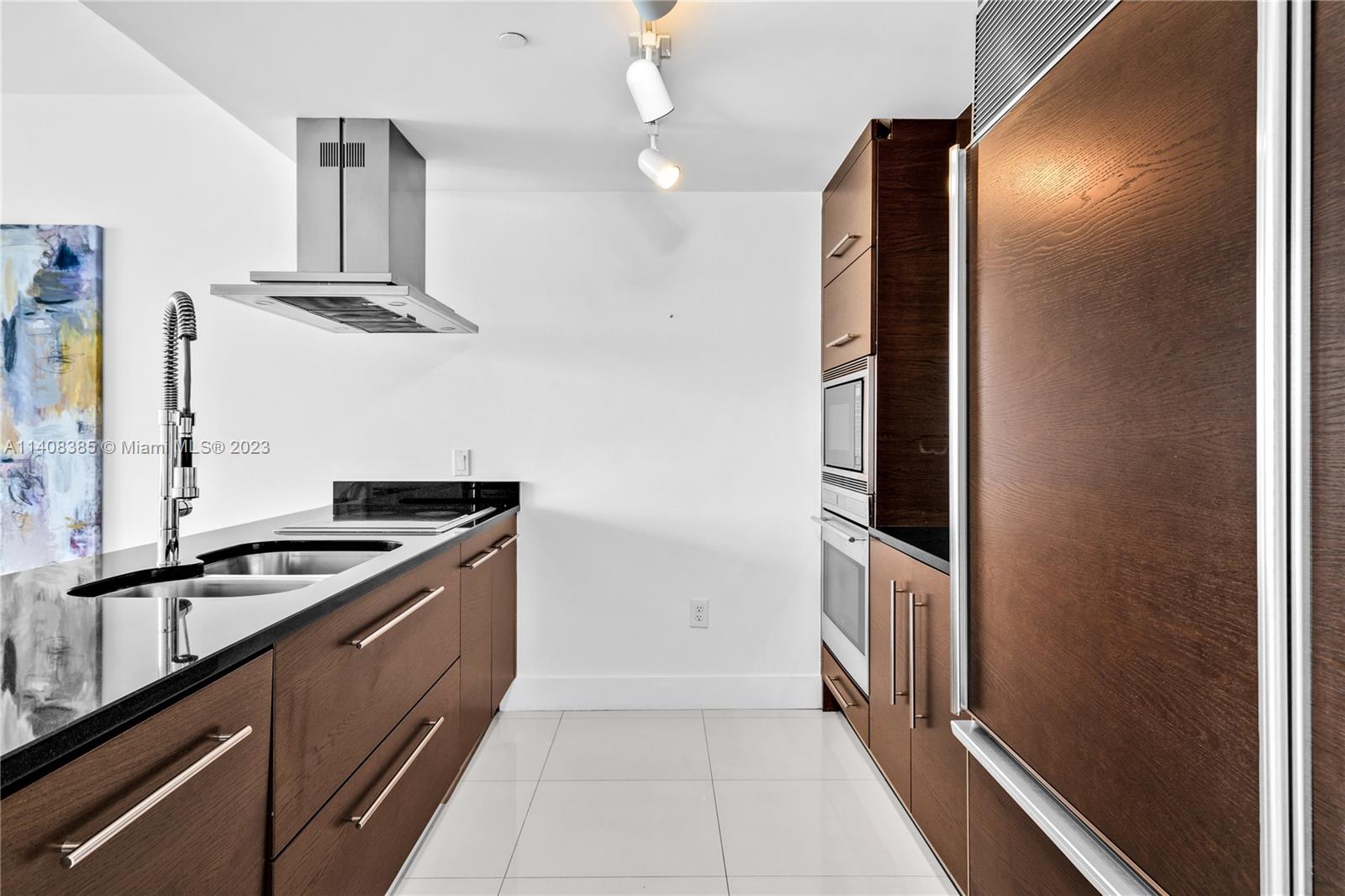 Brickell Miami, FL 33131 - Photo 8 of 25 a kitchen with stainless steel appliances granite countertop a stove and a refrigerator