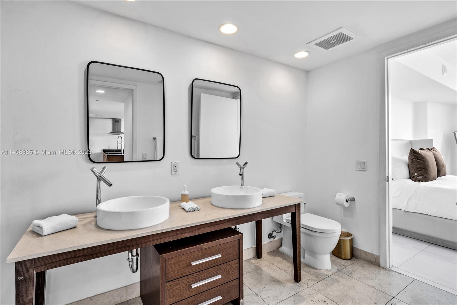 Brickell Miami, FL 33131 - Photo 10 of 25 a bathroom with double sink and a mirror