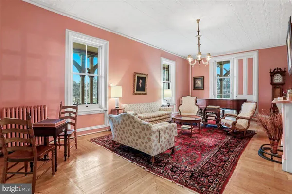 a living room with furniture and a chandelier