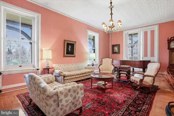 a living room with furniture a fireplace and large windows