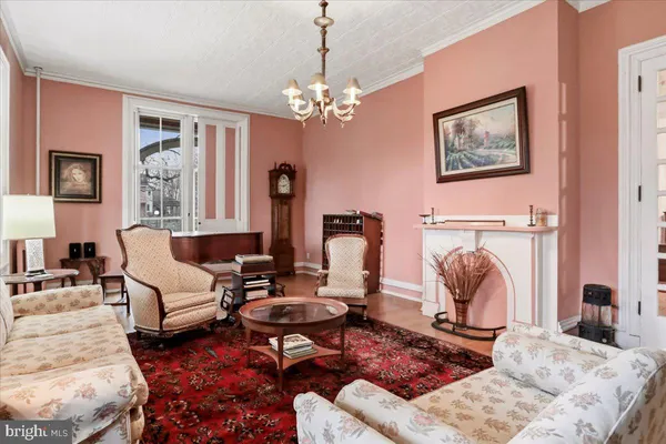 a living room with furniture and a book shelf