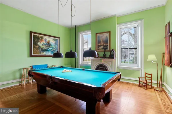 a bedroom with a bed a chandelier and a mirror