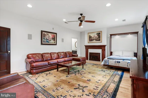 a bedroom with a bed lamps and wooden floor