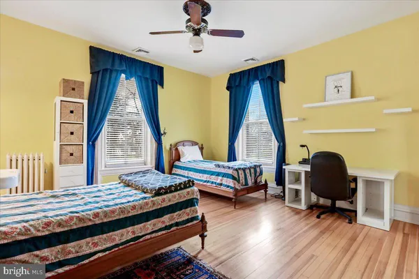a view of a patio with couches table and chairs and wooden floor